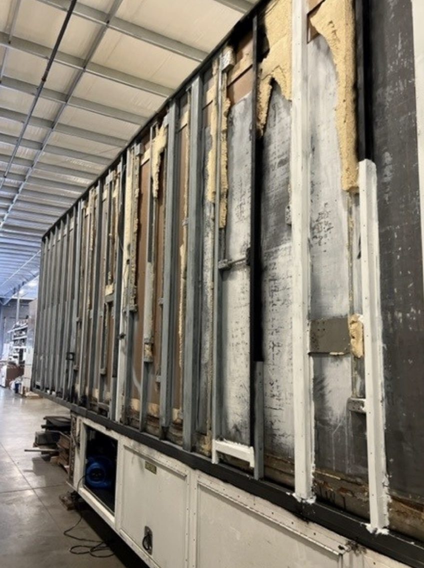 Mobile coach with exterior skin removed for refurbishment