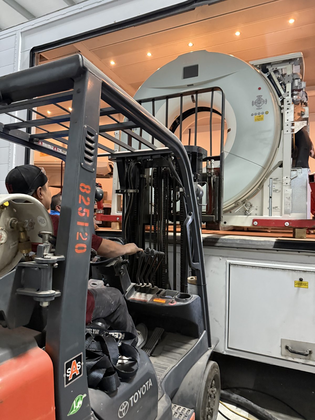 CT gantry loaded into a mobile coach by forklift