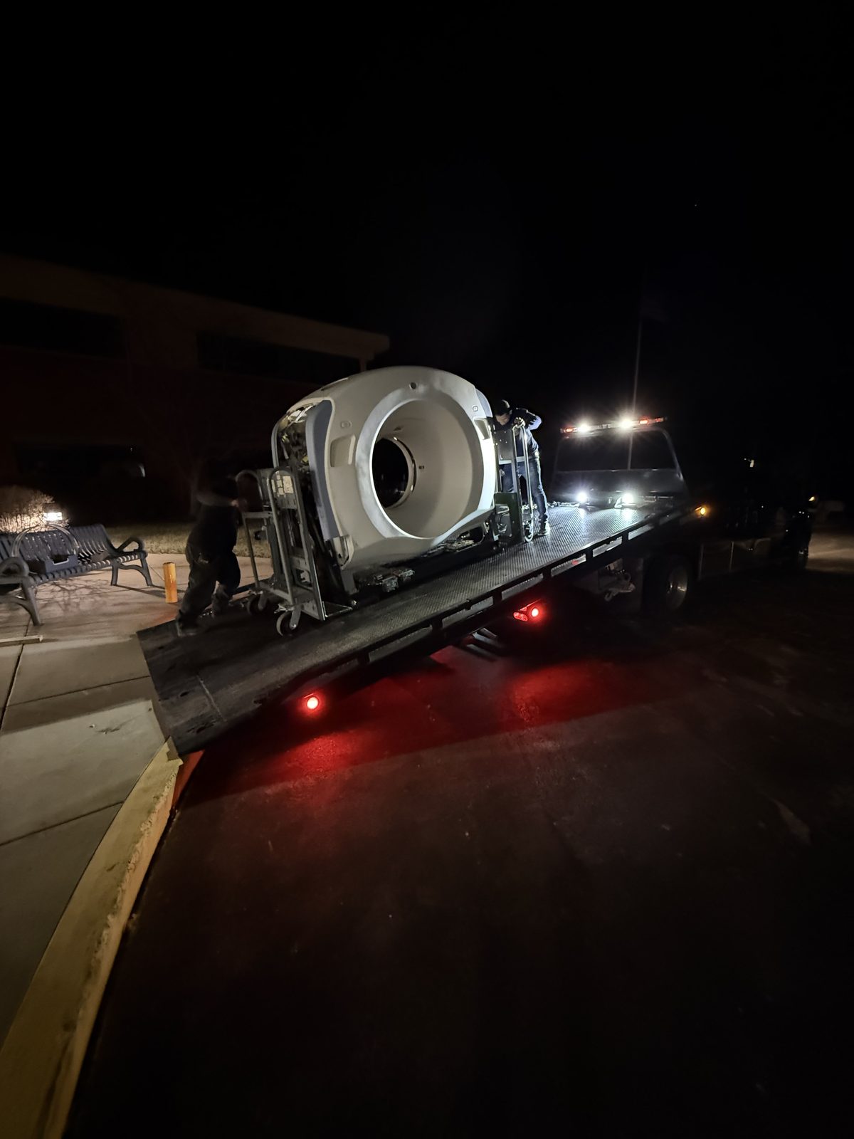 CT scanner de-installed and loaded onto flatbed at night