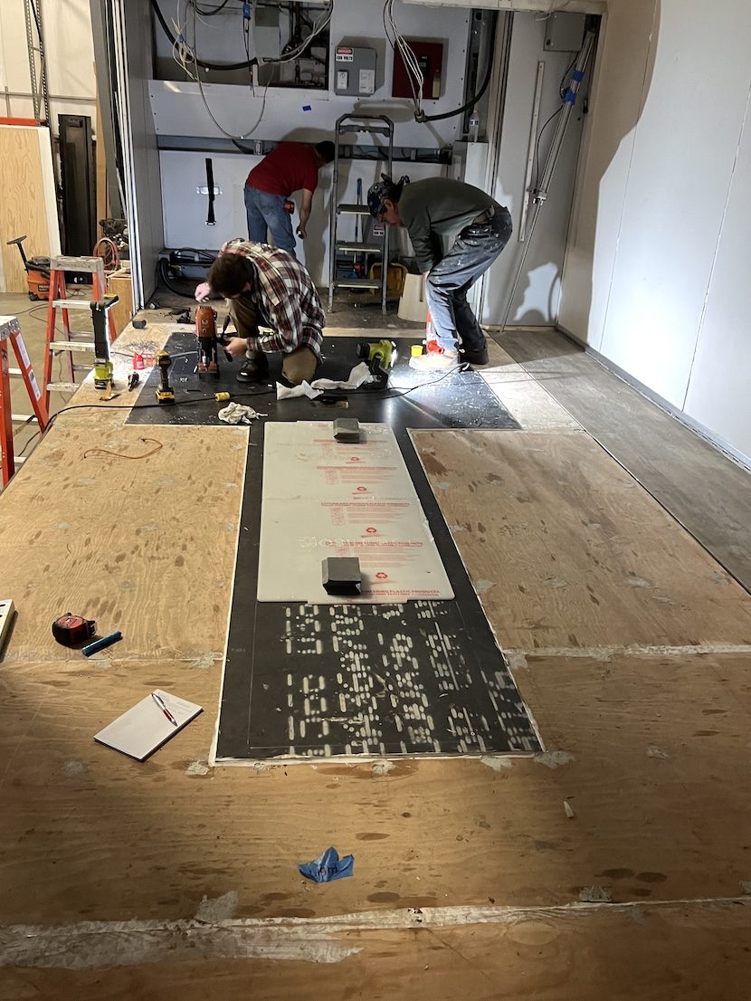 Crew installing flooring in a new imaging suite