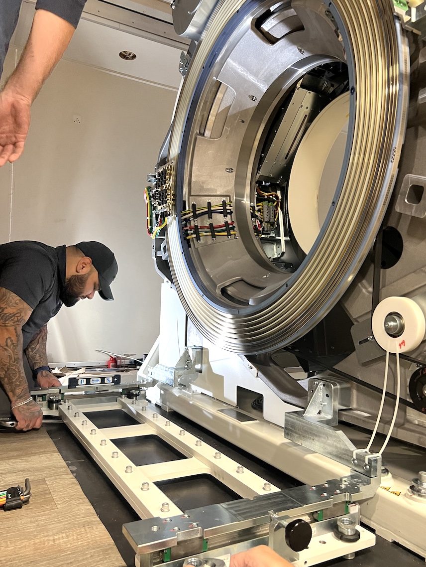 Engineer installing United Imaging uMI 550 CT gantry on rails